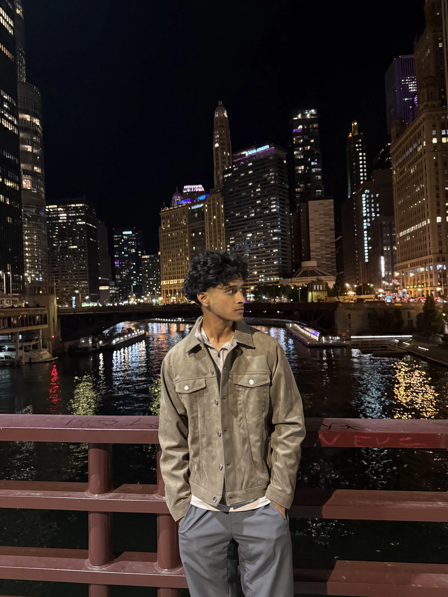 Dev on a bridge over the Chicago River at night
