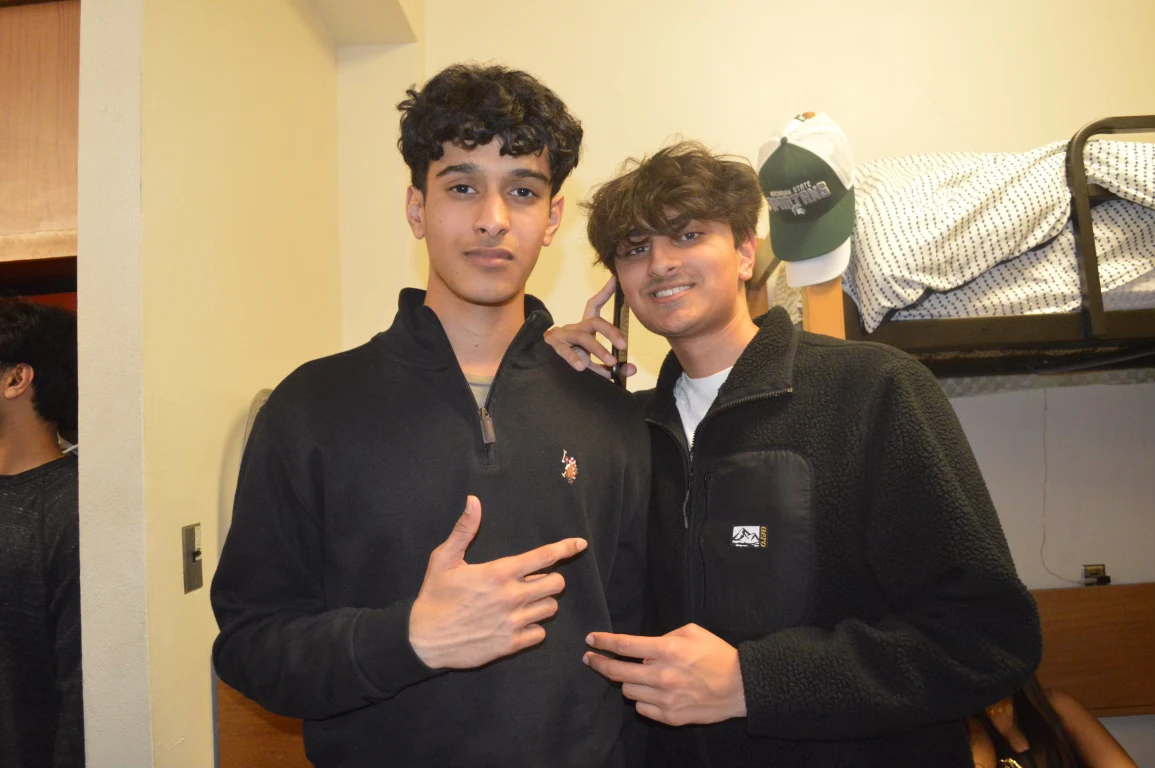 Dev with a friend in a dorm room